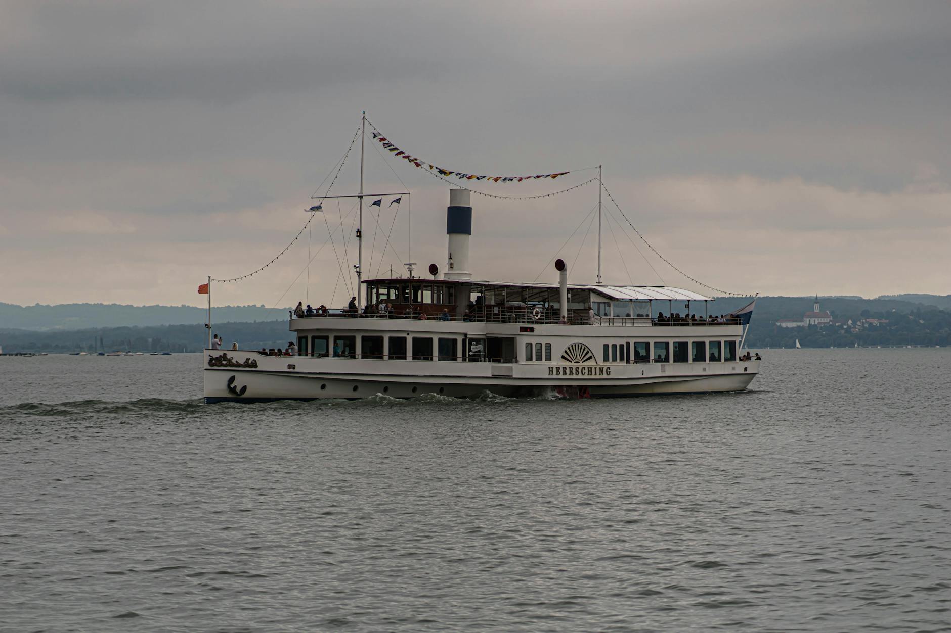 Tourist boat carrying visitors across calm reservoir waters during guided tour