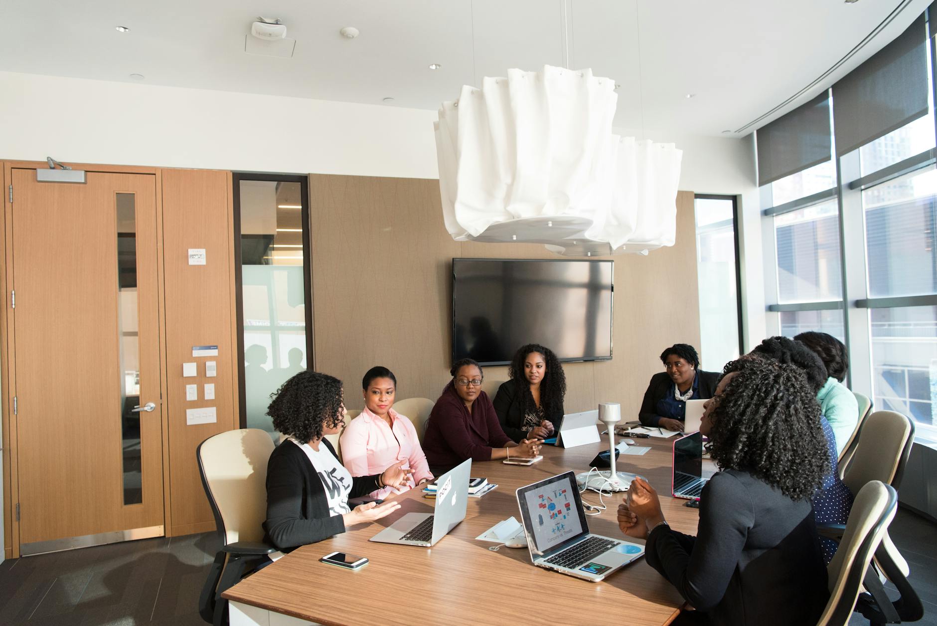 Business executives in professional attire during a boardroom meeting