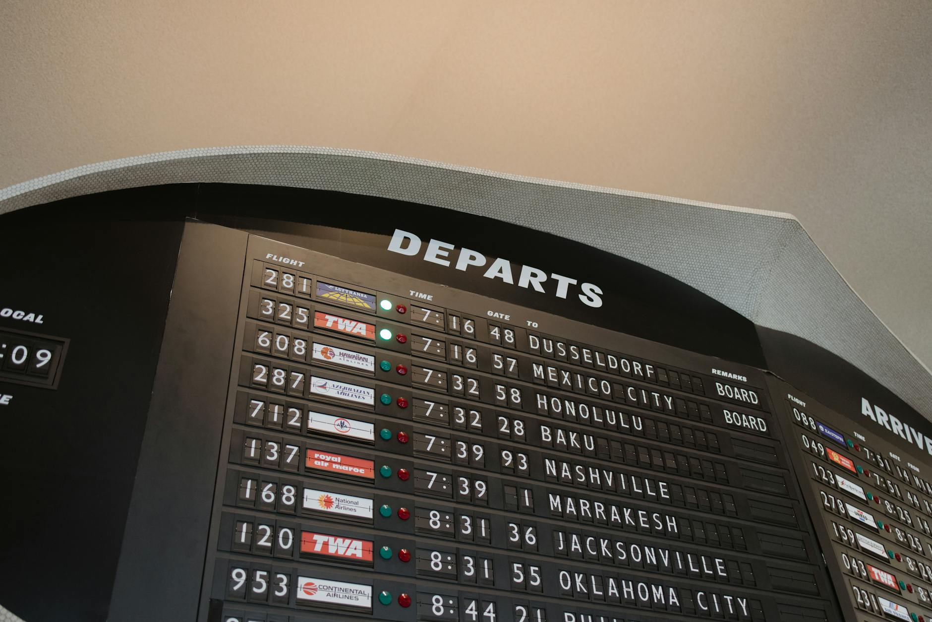 Digital airport departure board showing flight information and gate numbers
