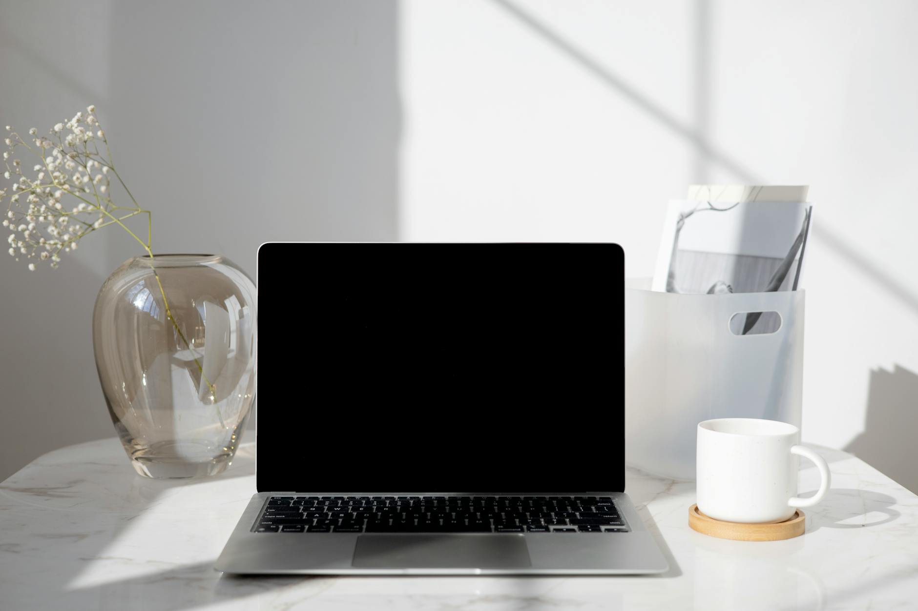 Professional workspace setup with laptop and office supplies on a desk