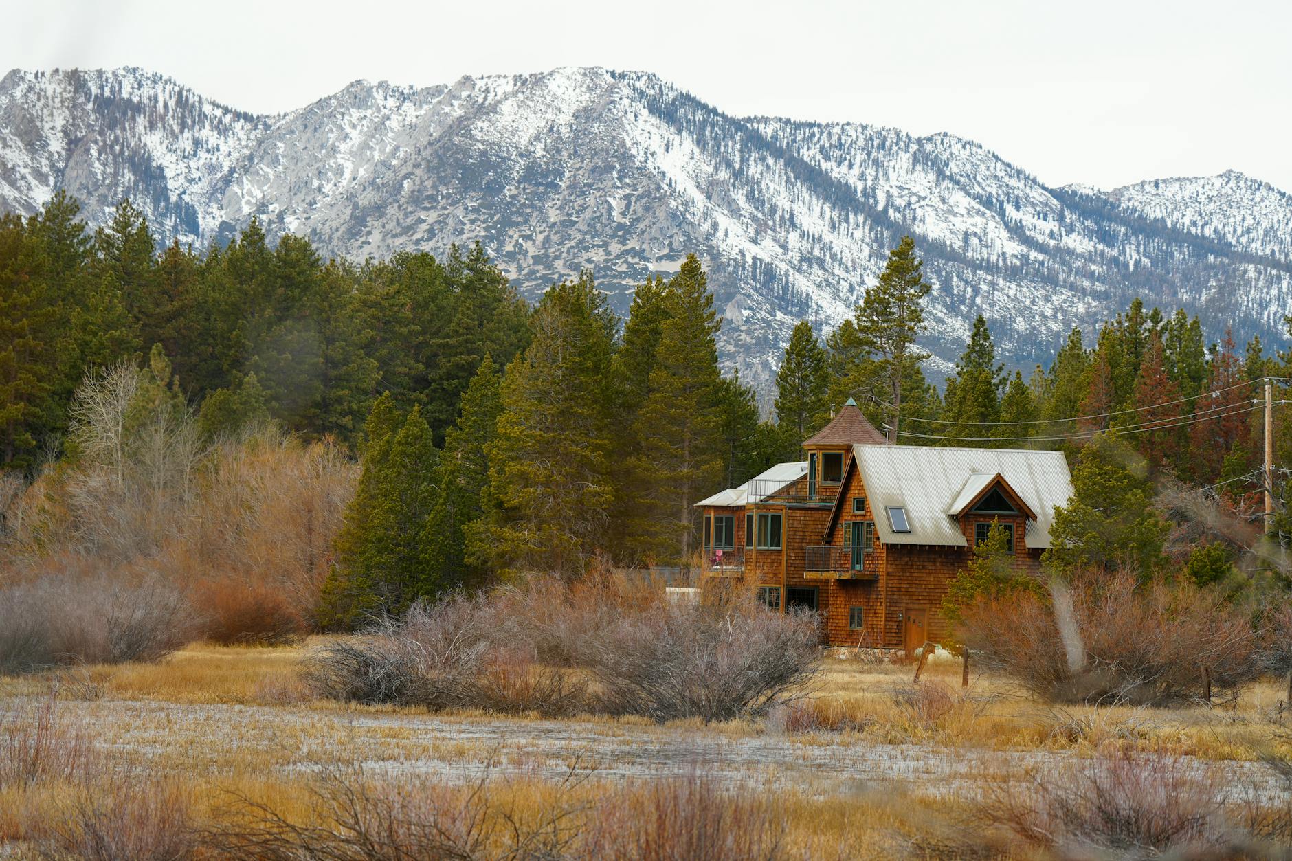 Peaceful mountain retreat setting with wooden structures surrounded by forest landscape
