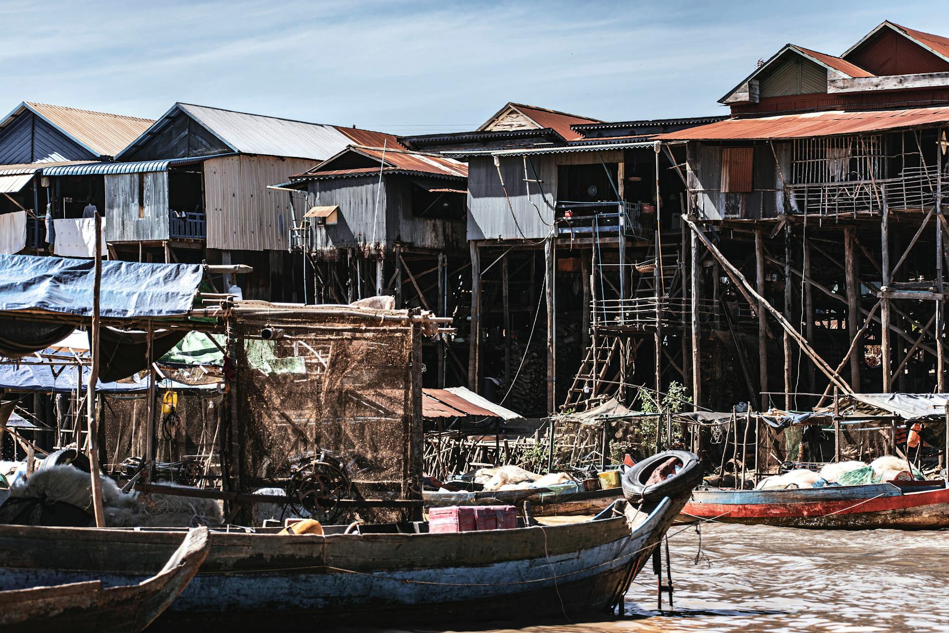 Remote Nordic fishing village with traditional houses near water and mountainous coastline