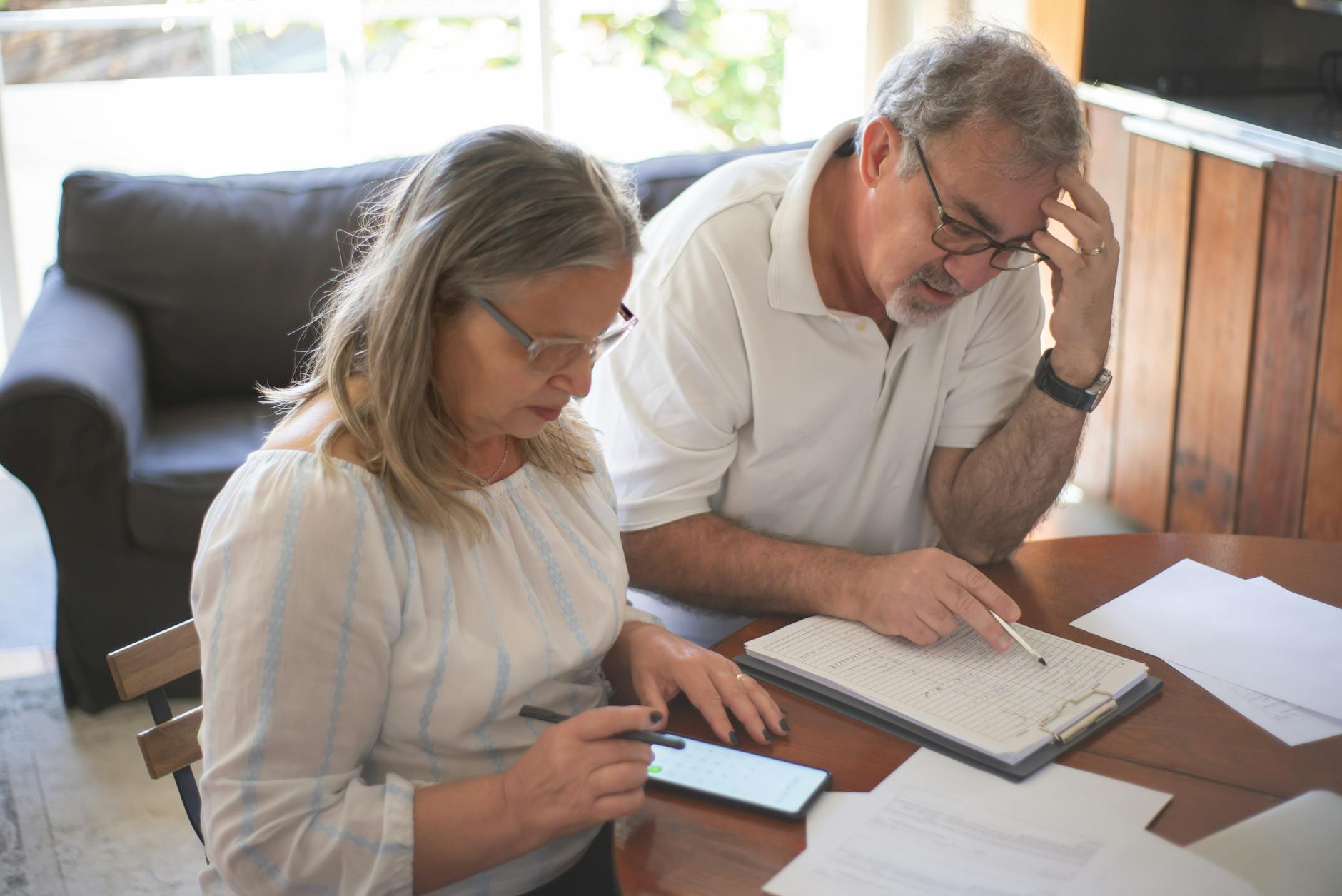 Senior couple reviewing documents and planning together at table