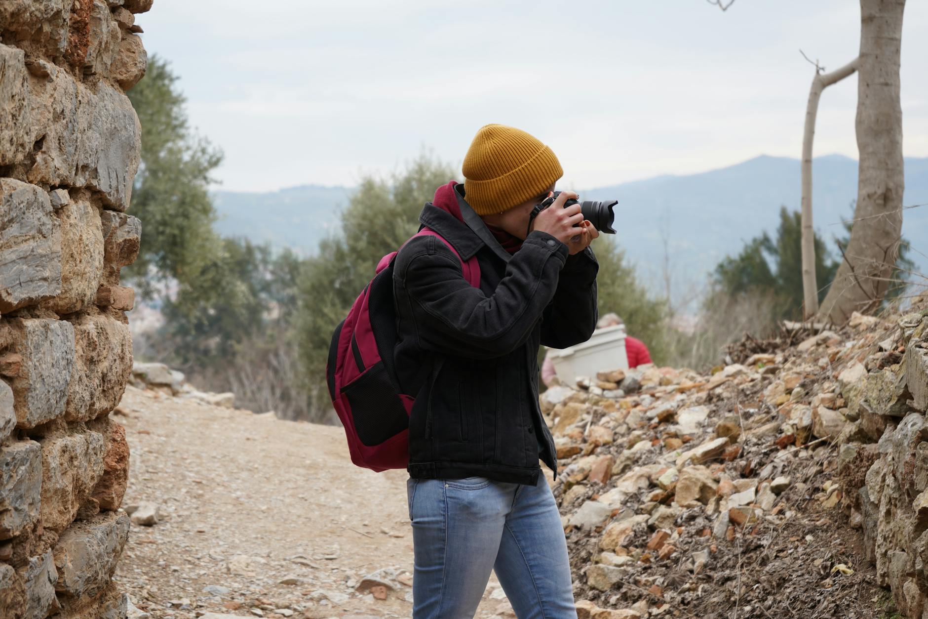 Photographer with camera capturing images in abandoned industrial setting