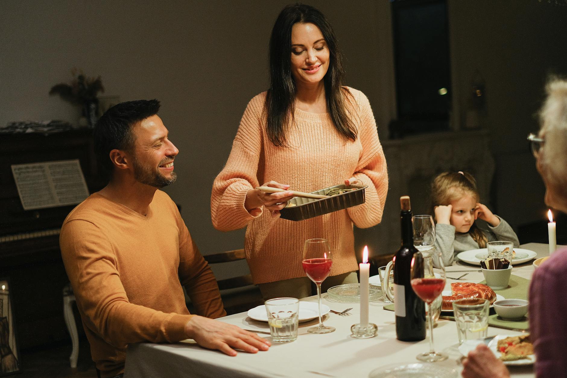 Family gathered around dinner table enjoying professionally prepared meal