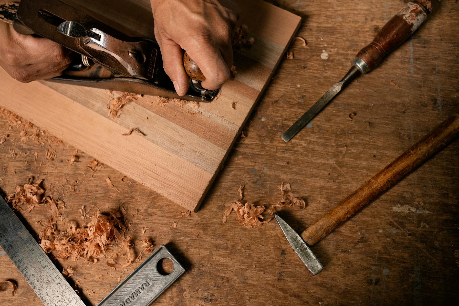 Traditional woodworking tools and materials on a crafting table