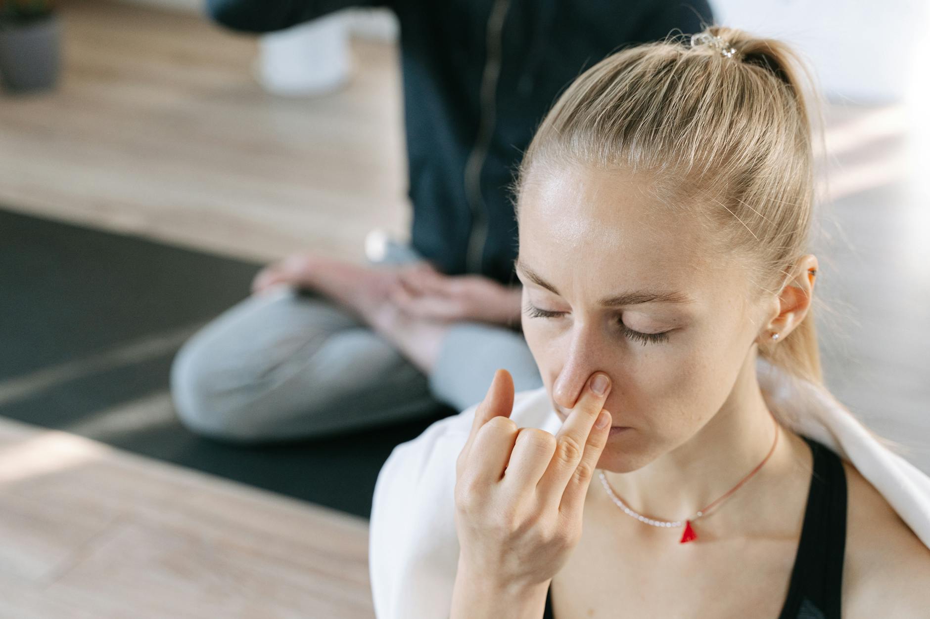 Close-up of person practicing controlled breathing exercises with eyes closed