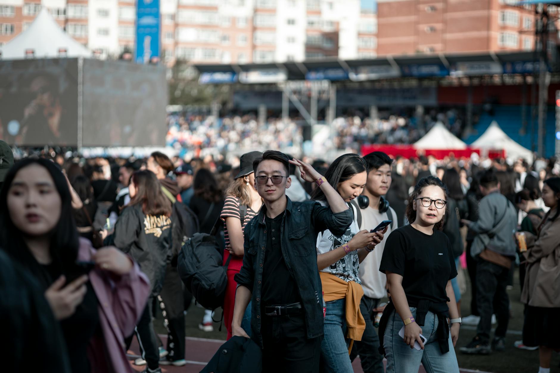 Group of young travelers sitting together in a hostel common area having conversations