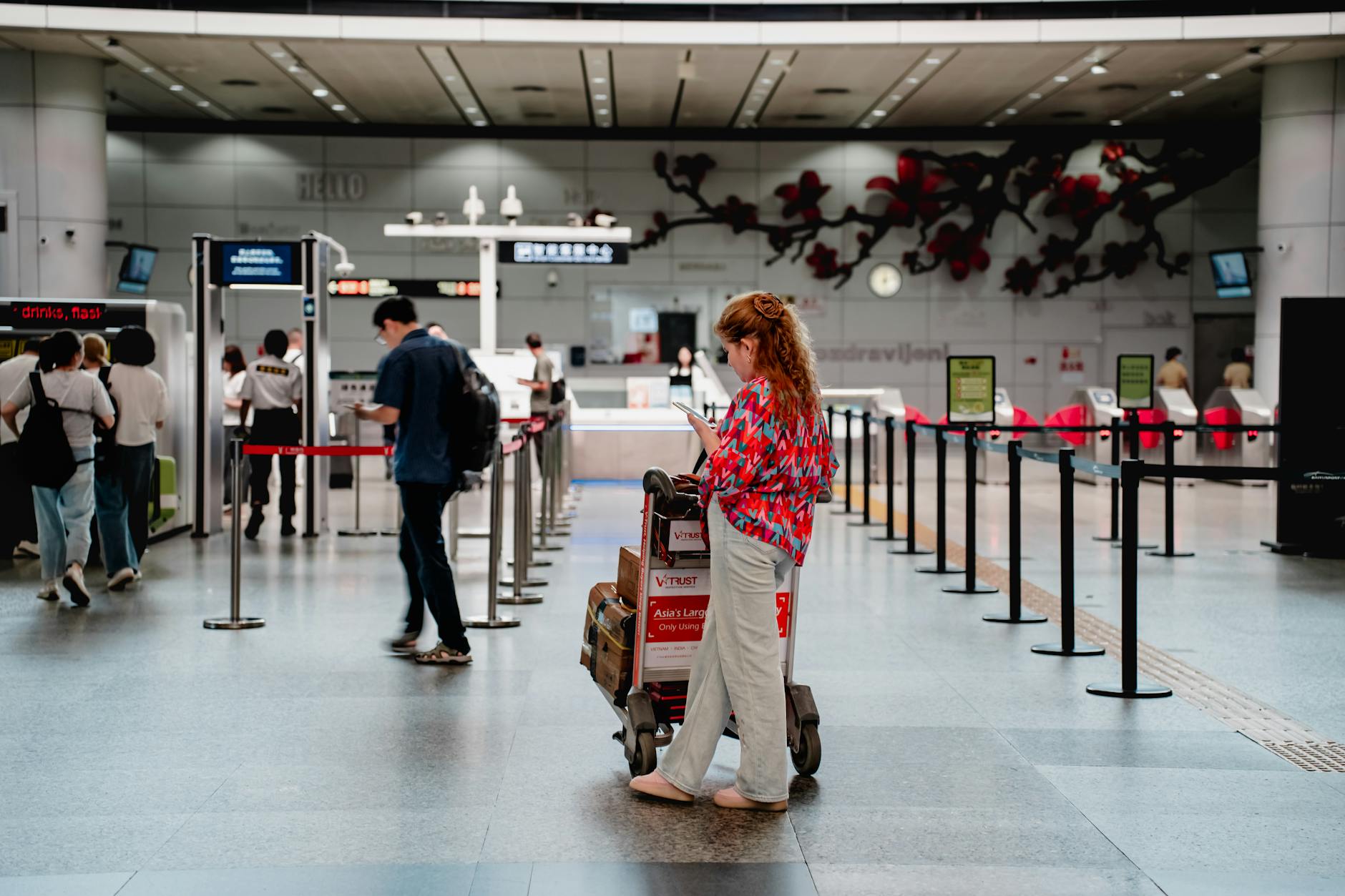 Airport security checkpoint with travelers going through screening process