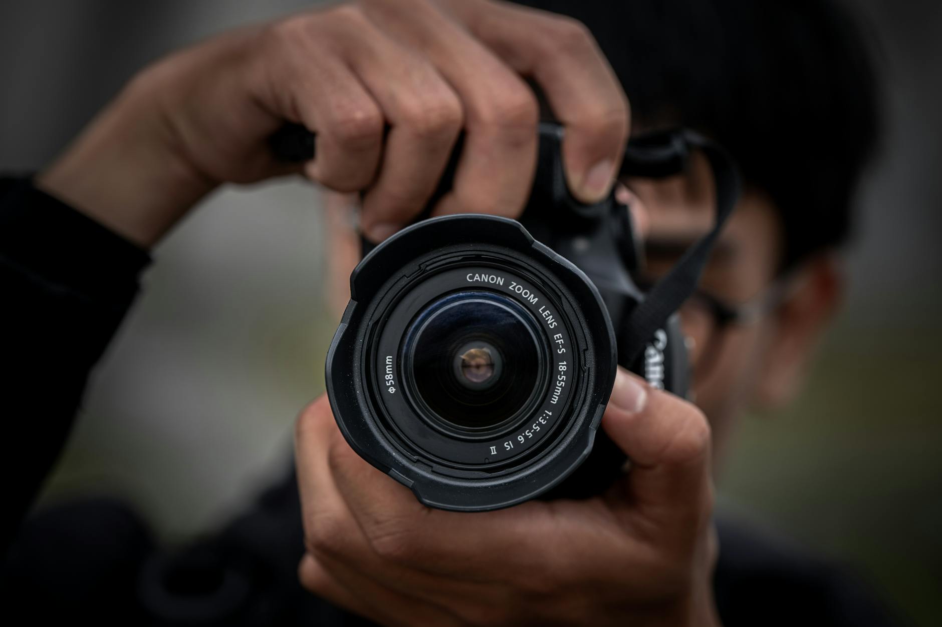 Photographer with camera equipment capturing night sky in cold weather conditions