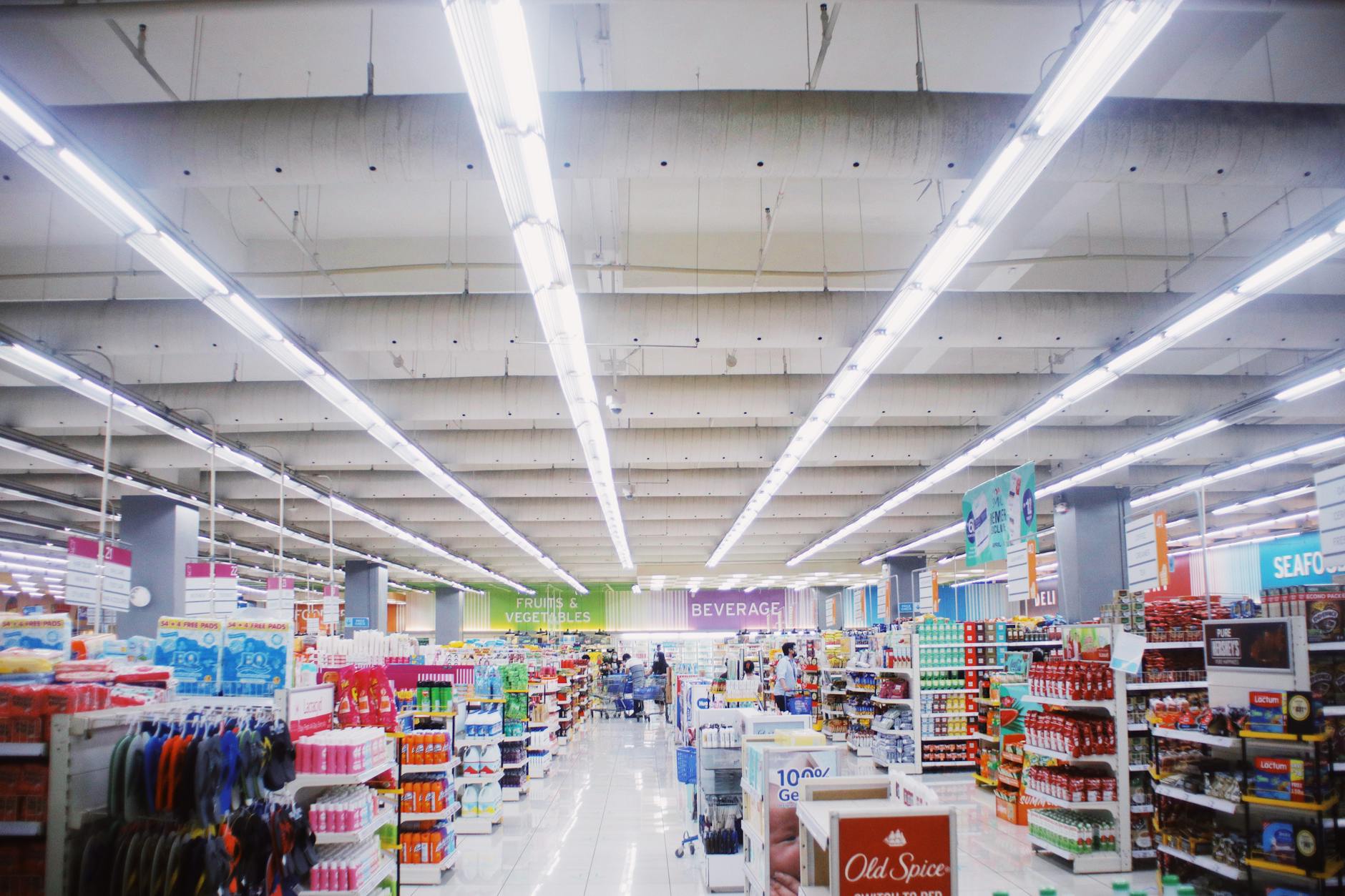 Overhead directional signs in international supermarket aisle