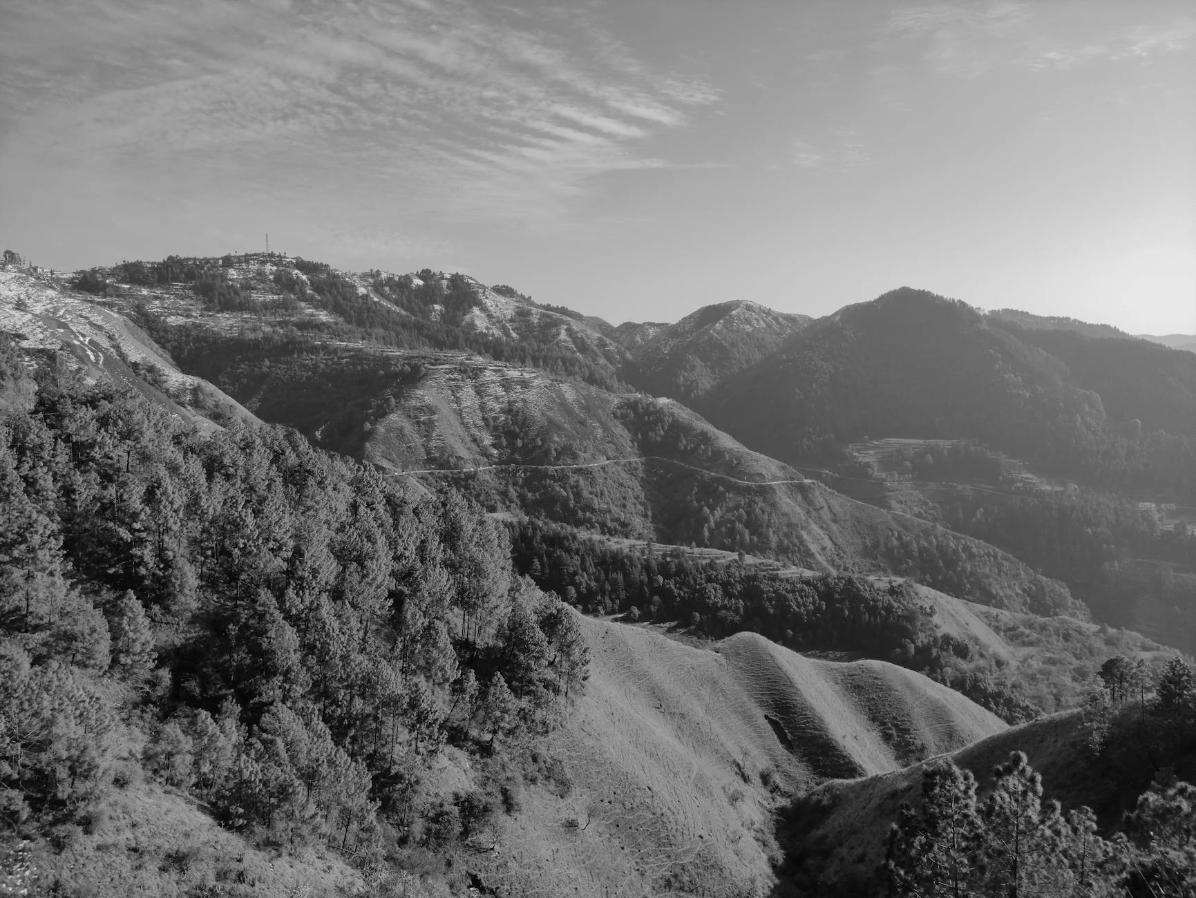 Dramatic Himalayan mountain peaks with snow and rocky terrain under clear blue sky