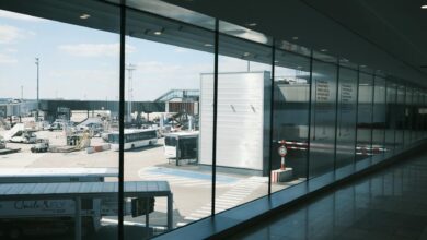 Traveler walking through airport terminal with single carry-on bag demonstrating hassle-free minimalist travel approach