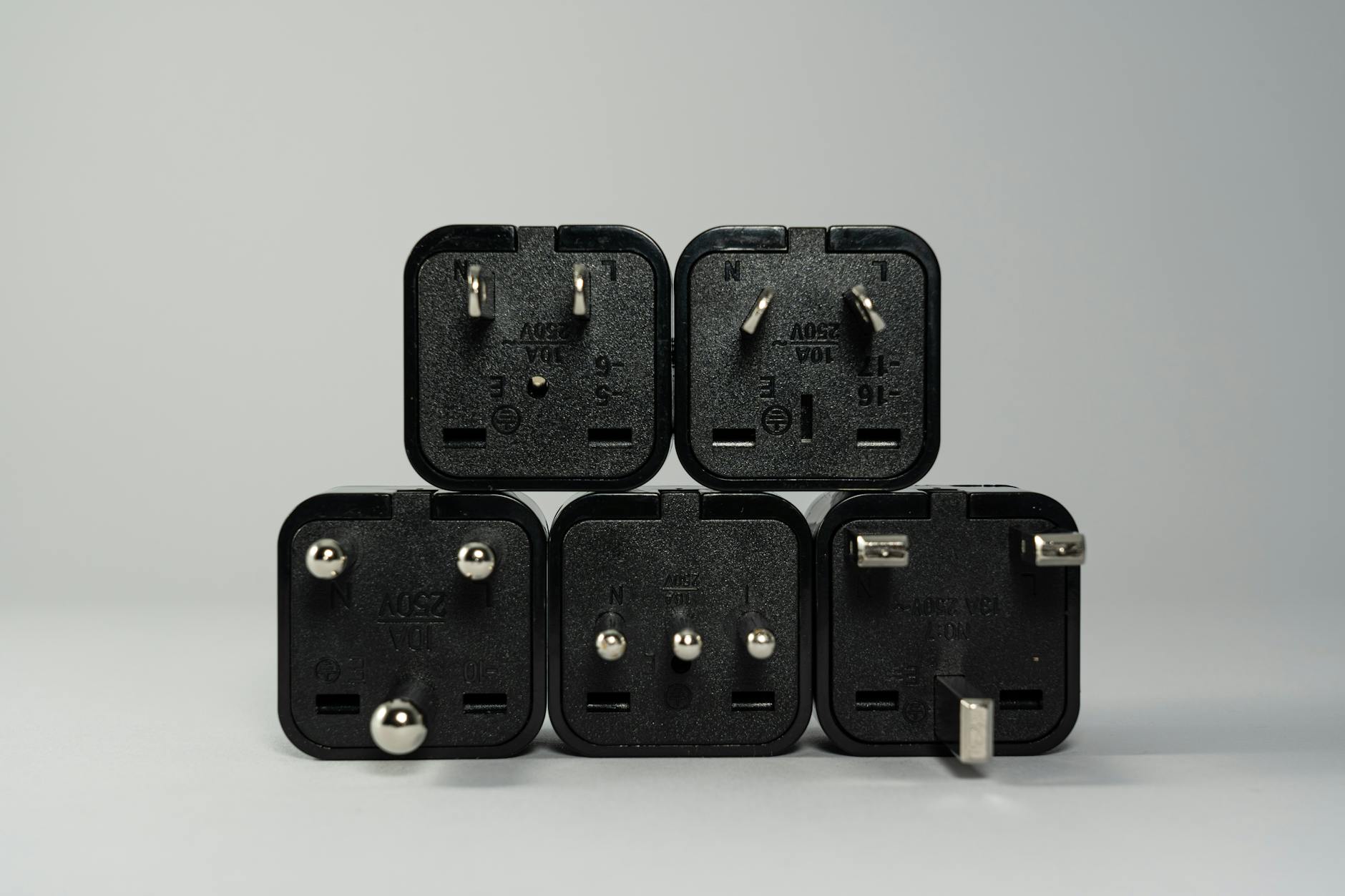 International power adapters and charging cables arranged on travel packing surface