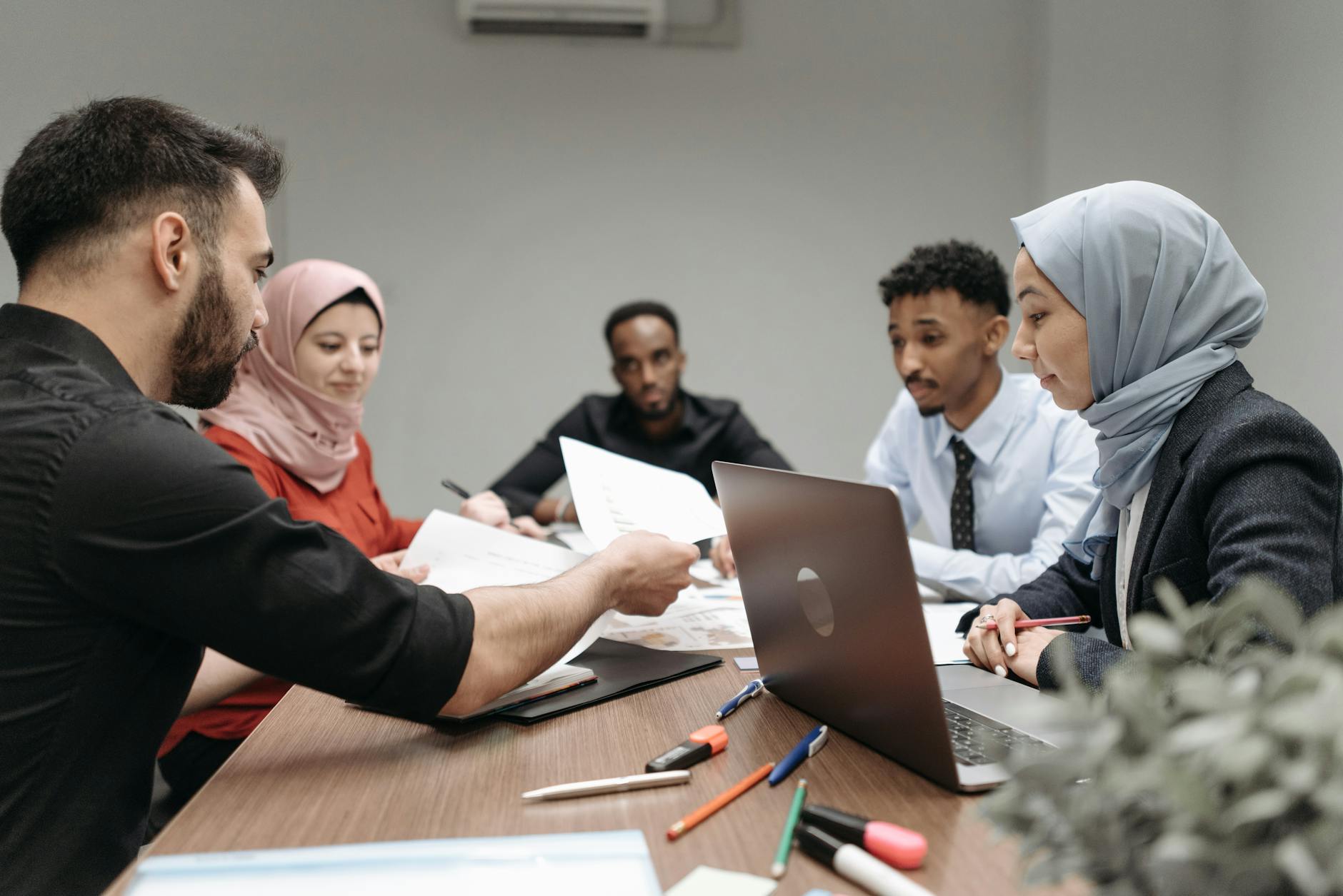 Small group of people collaborating and sharing skills in community setting