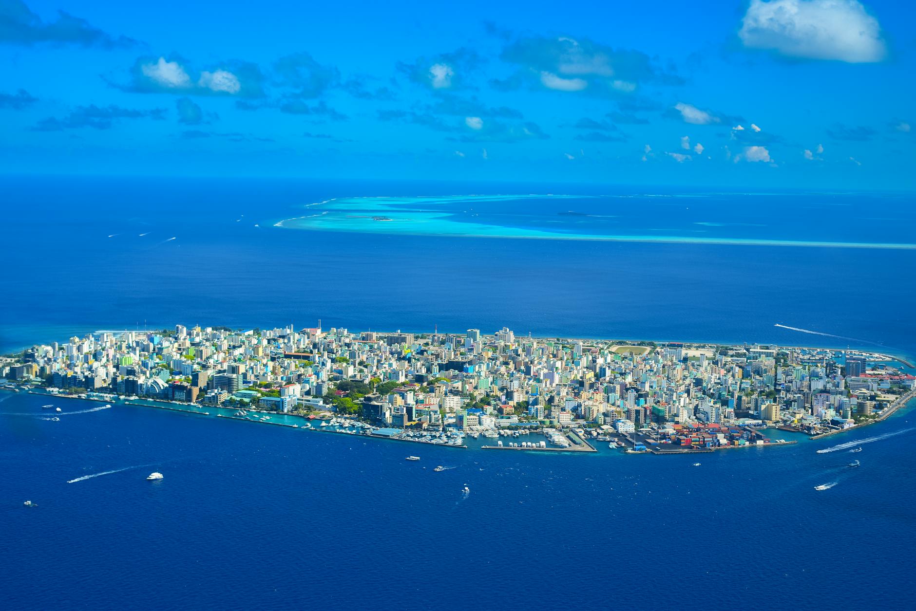 Aerial view of tropical island with clear blue waters and rocky coastline