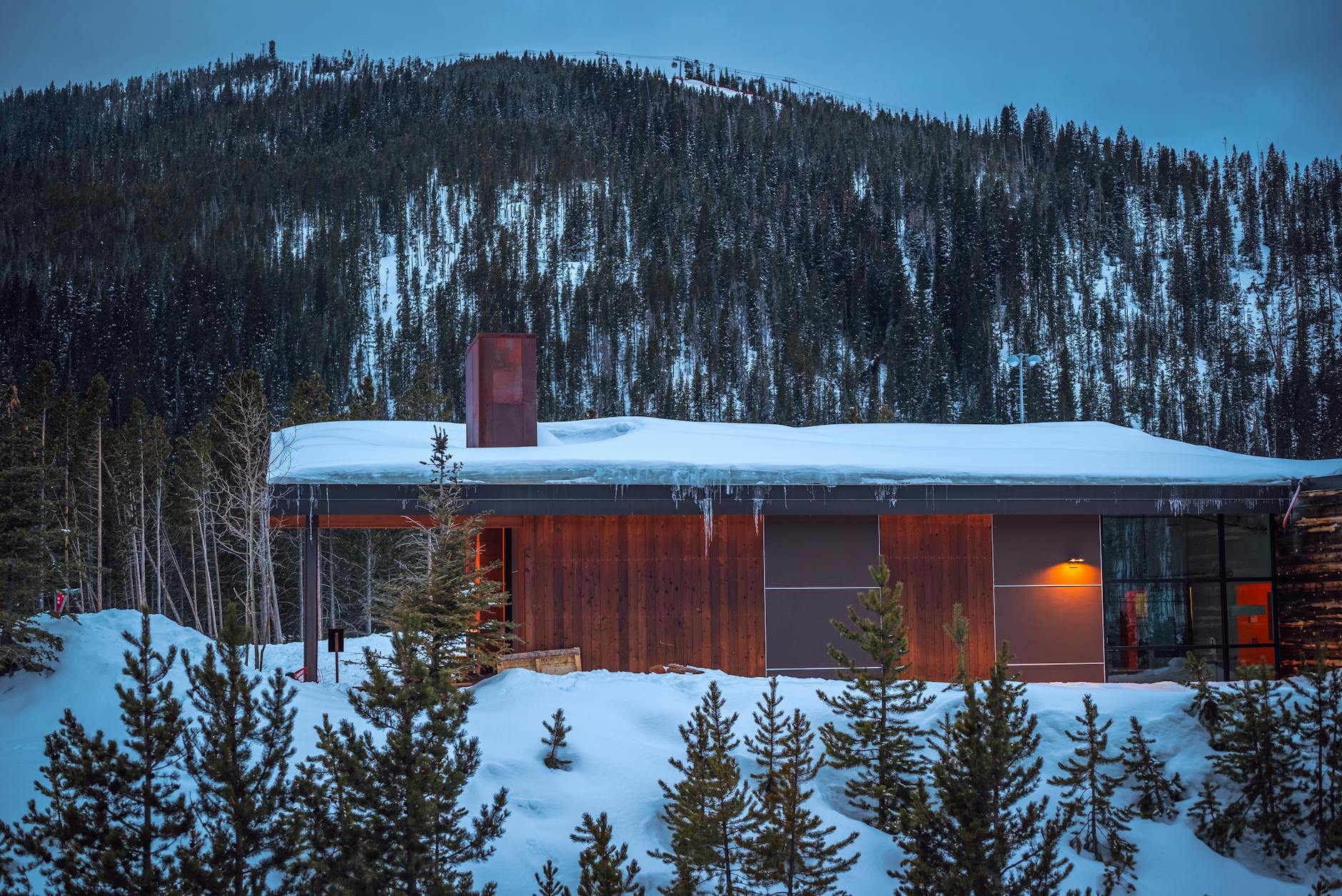 Rustic cabin or house in mountainous rural setting surrounded by nature