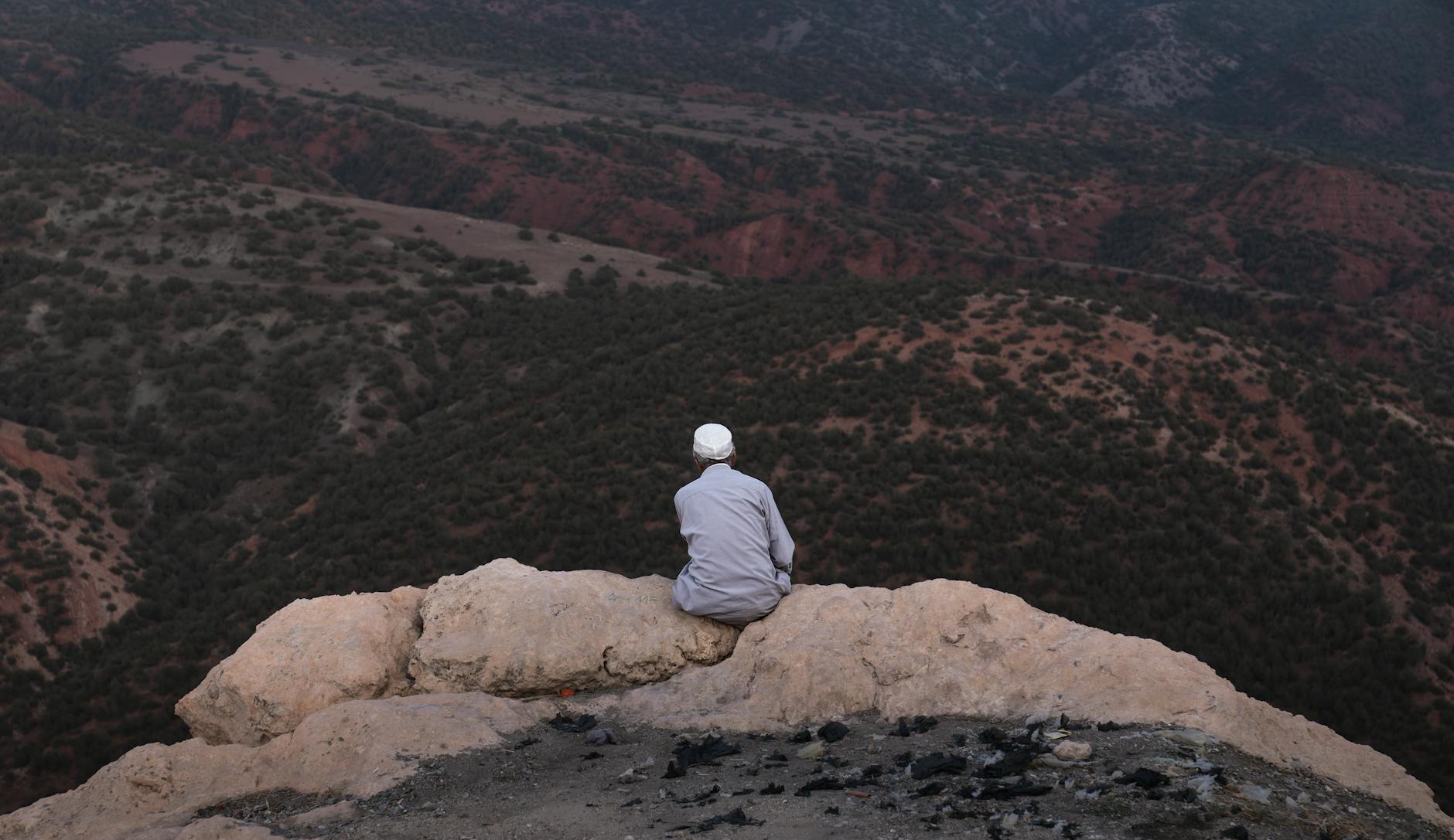 Dramatic sunset view over Atlas Mountain peaks with golden light on snow-covered summits
