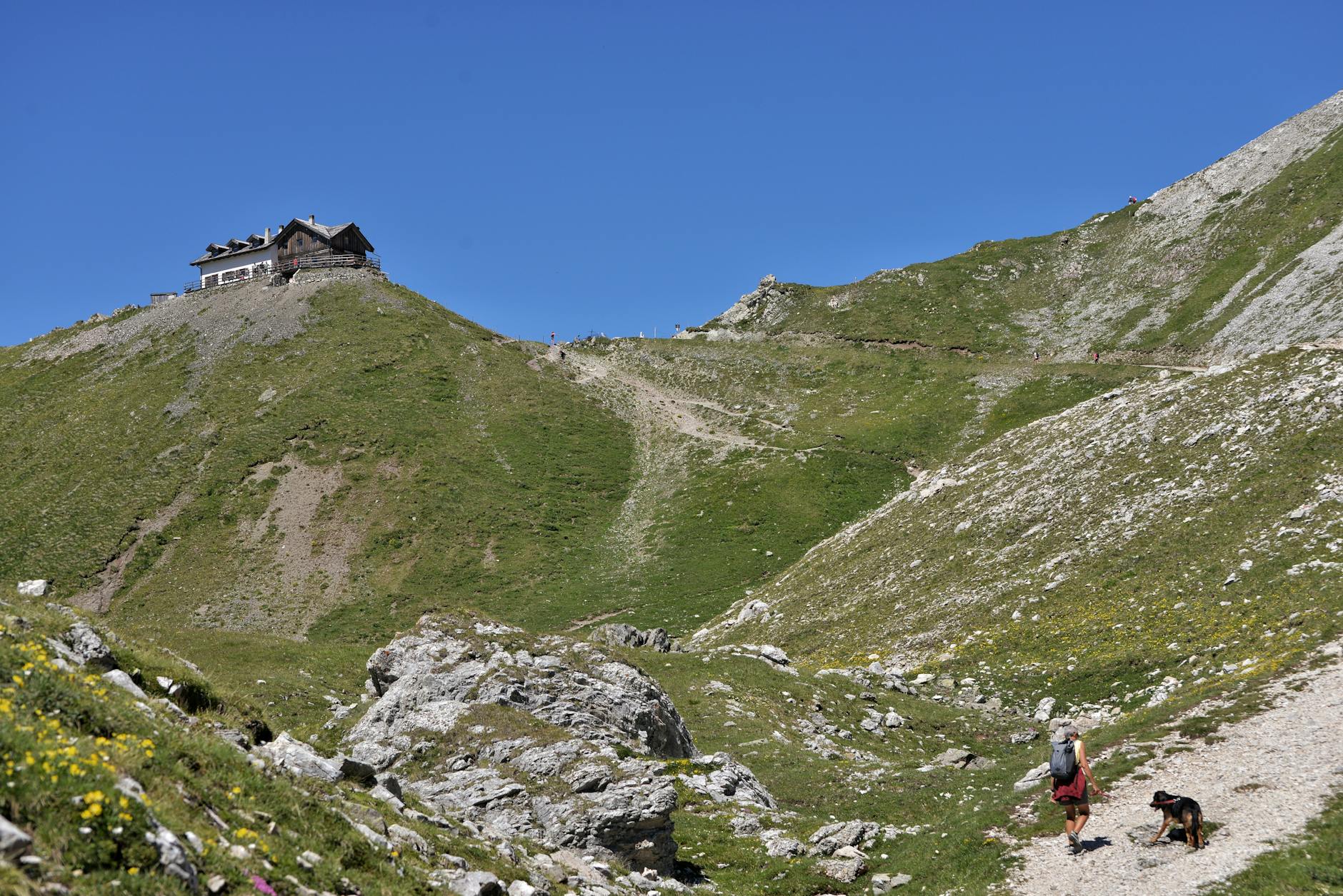 Scenic mountain hiking trail with person walking in distance
