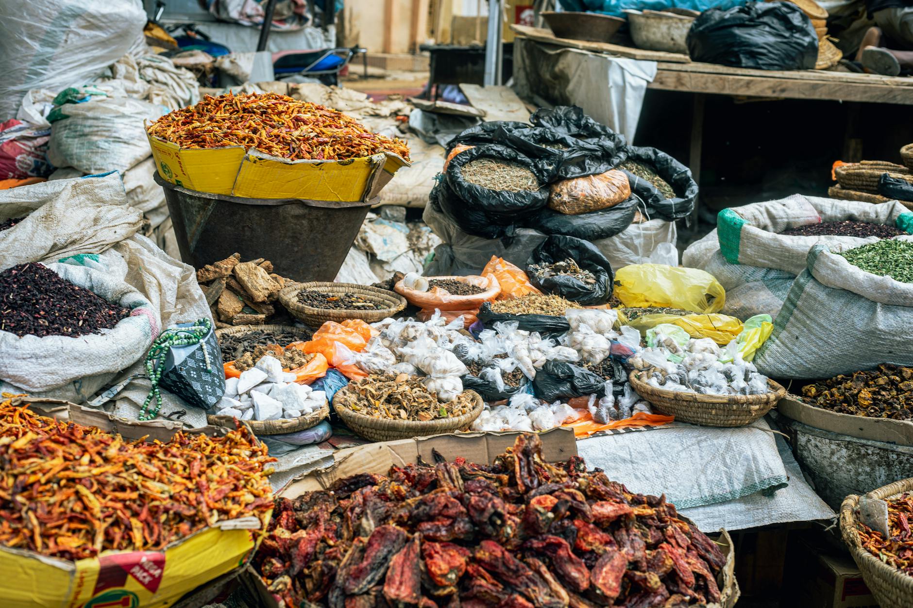 Traditional spice market display with various aromatic spices and vanilla beans