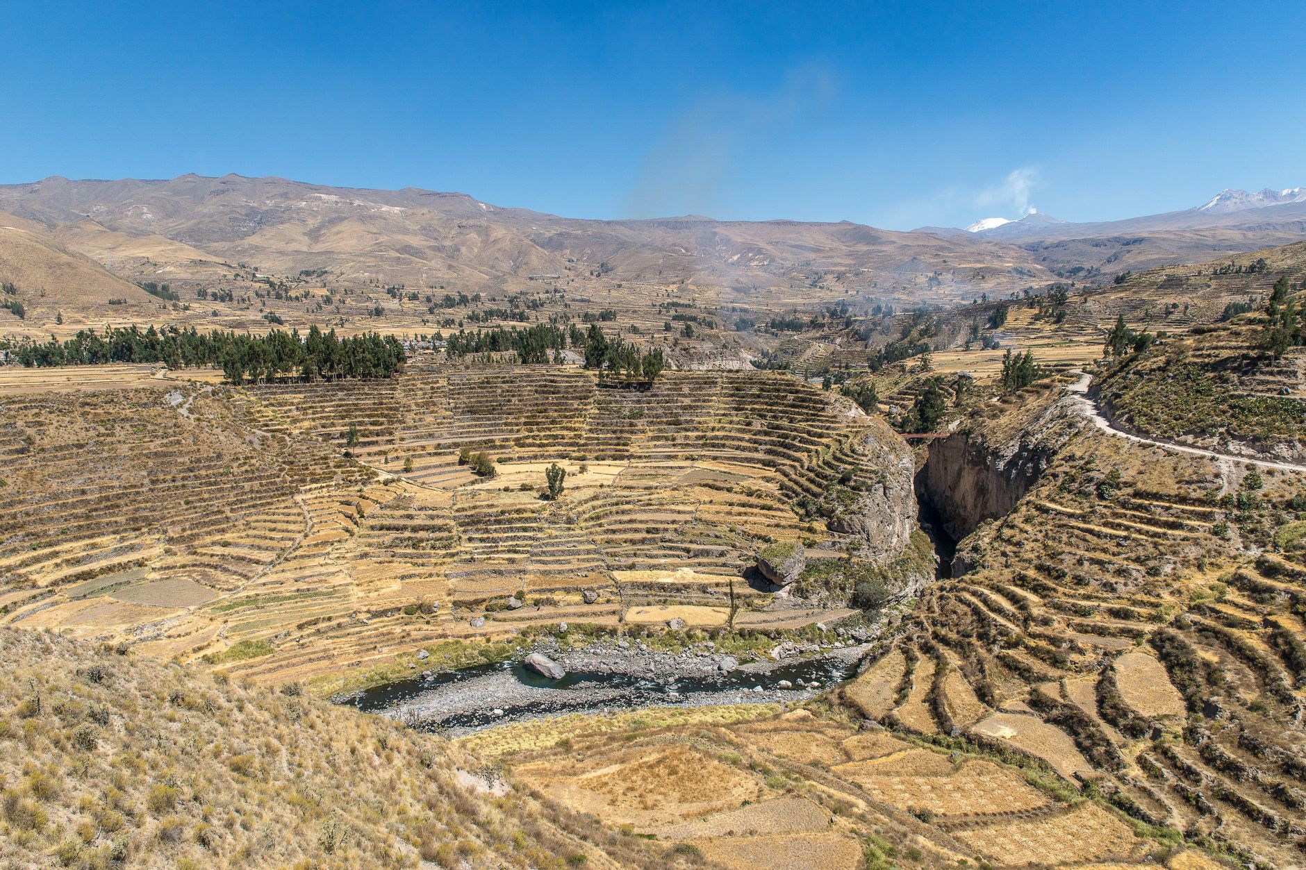 Aerial view of a deep canyon with terraced hillsides in the Peruvian Andes