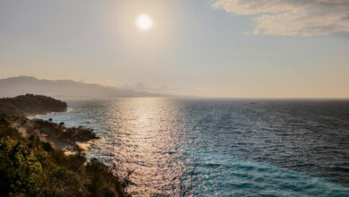 Clear blue Ionian waters along the Albanian Riviera coastline with rocky cliffs