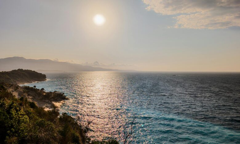Clear blue Ionian waters along the Albanian Riviera coastline with rocky cliffs