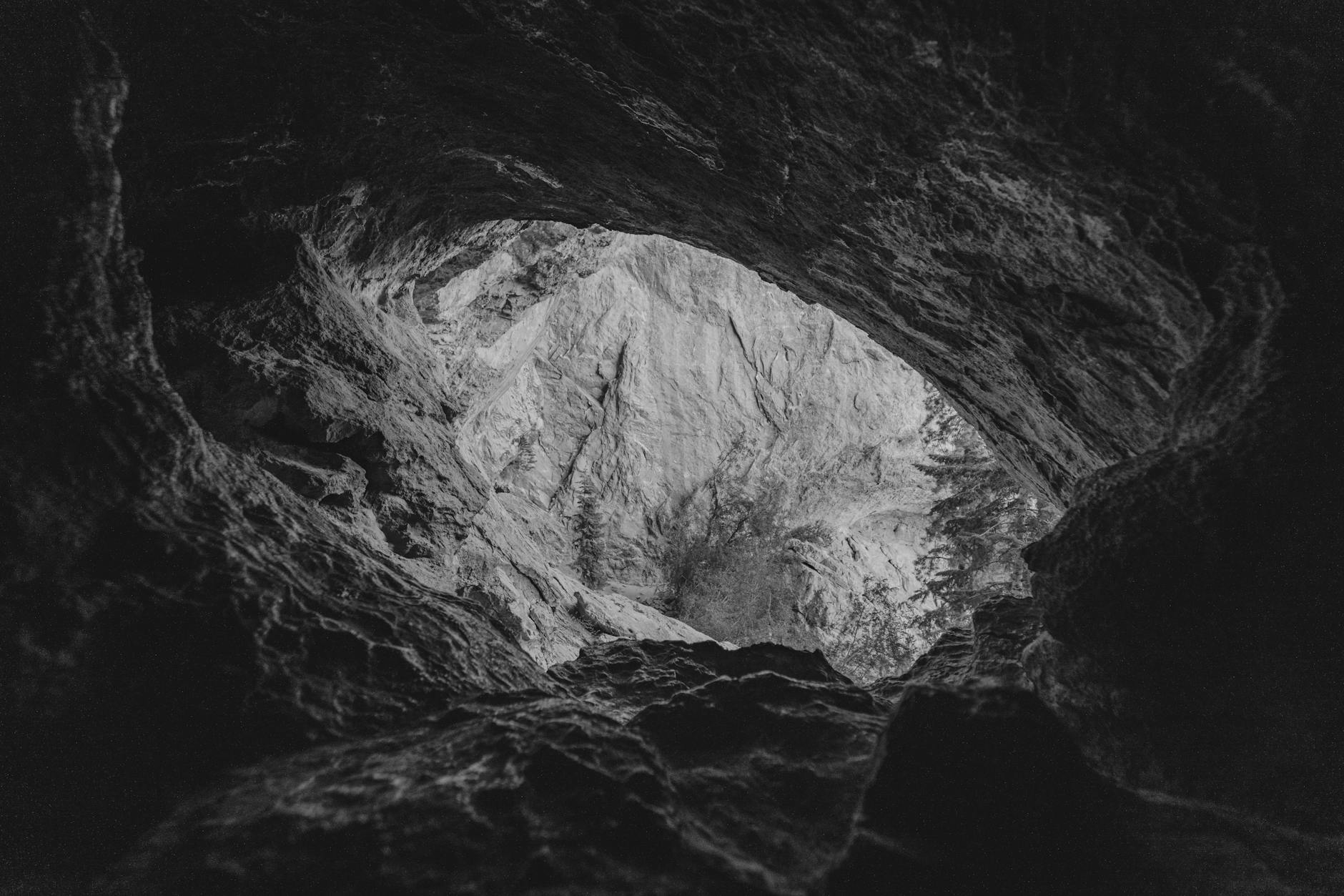 Desert landscape with natural rock formations and cave opening in arid terrain
