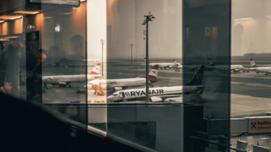 Modern airport boarding gate with passengers and electronic displays