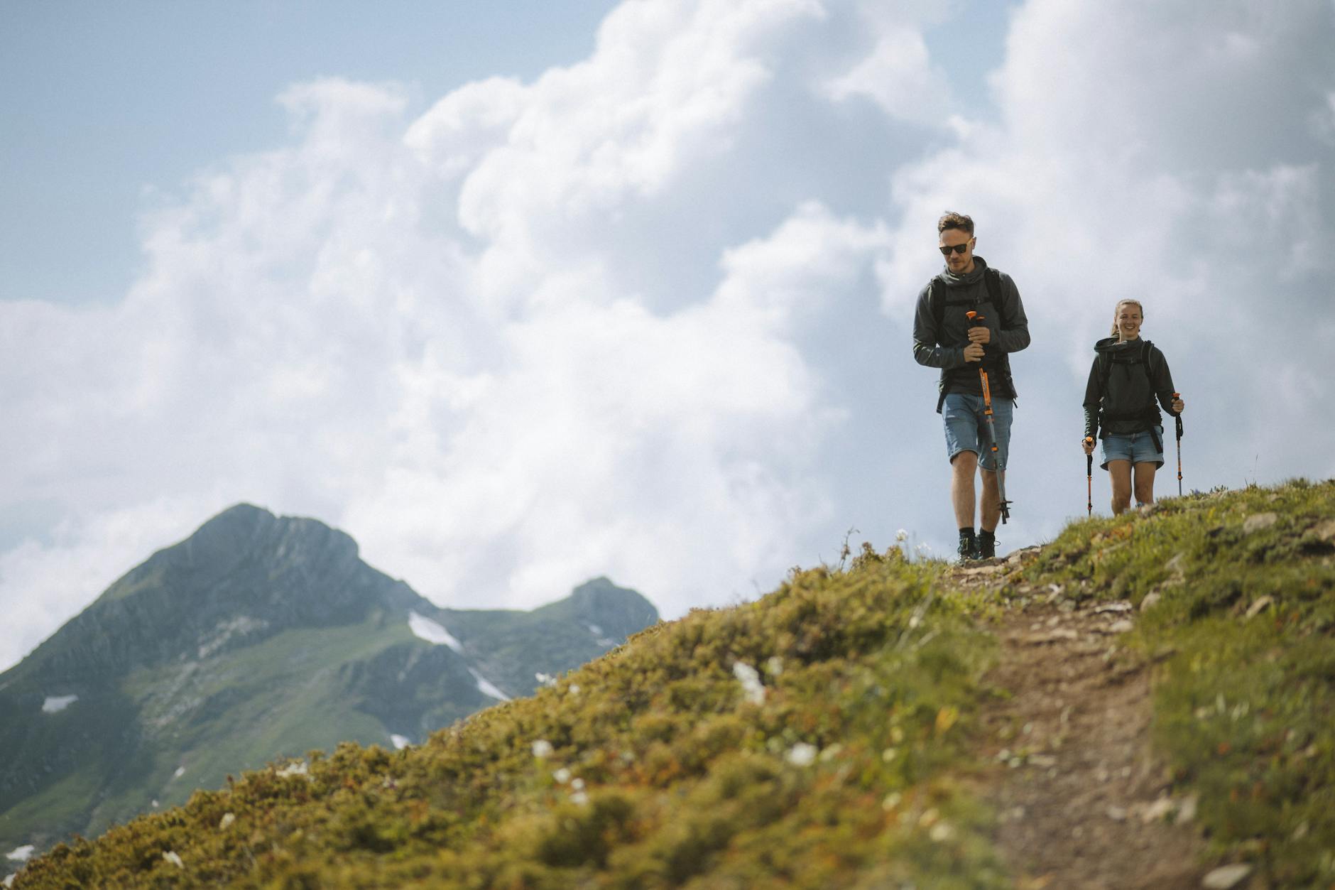 Hiker on a steep mountain trail with canyon walls visible in the background