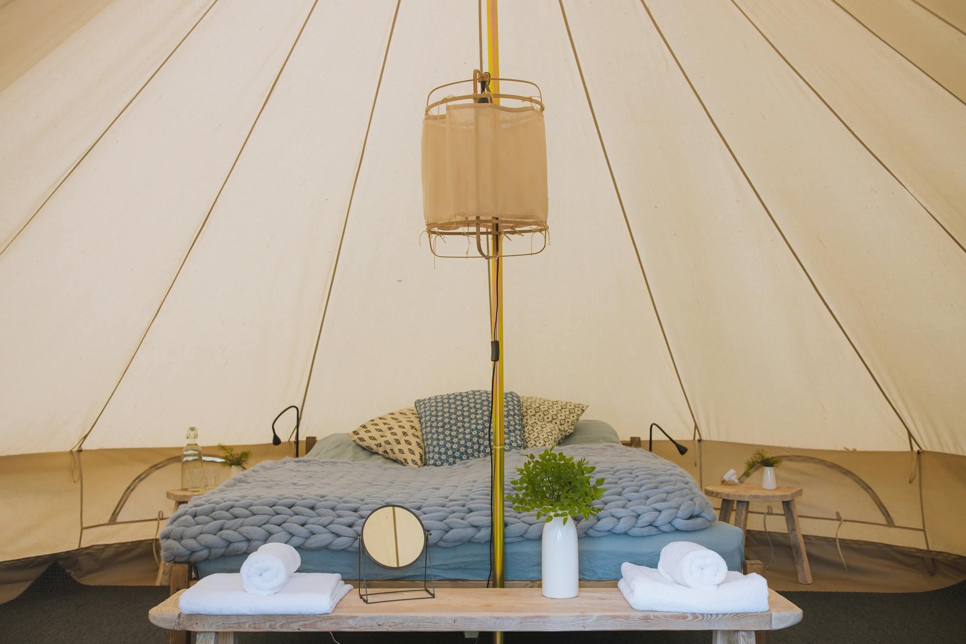 Elevated luxury tent accommodation with wooden platform overlooking water