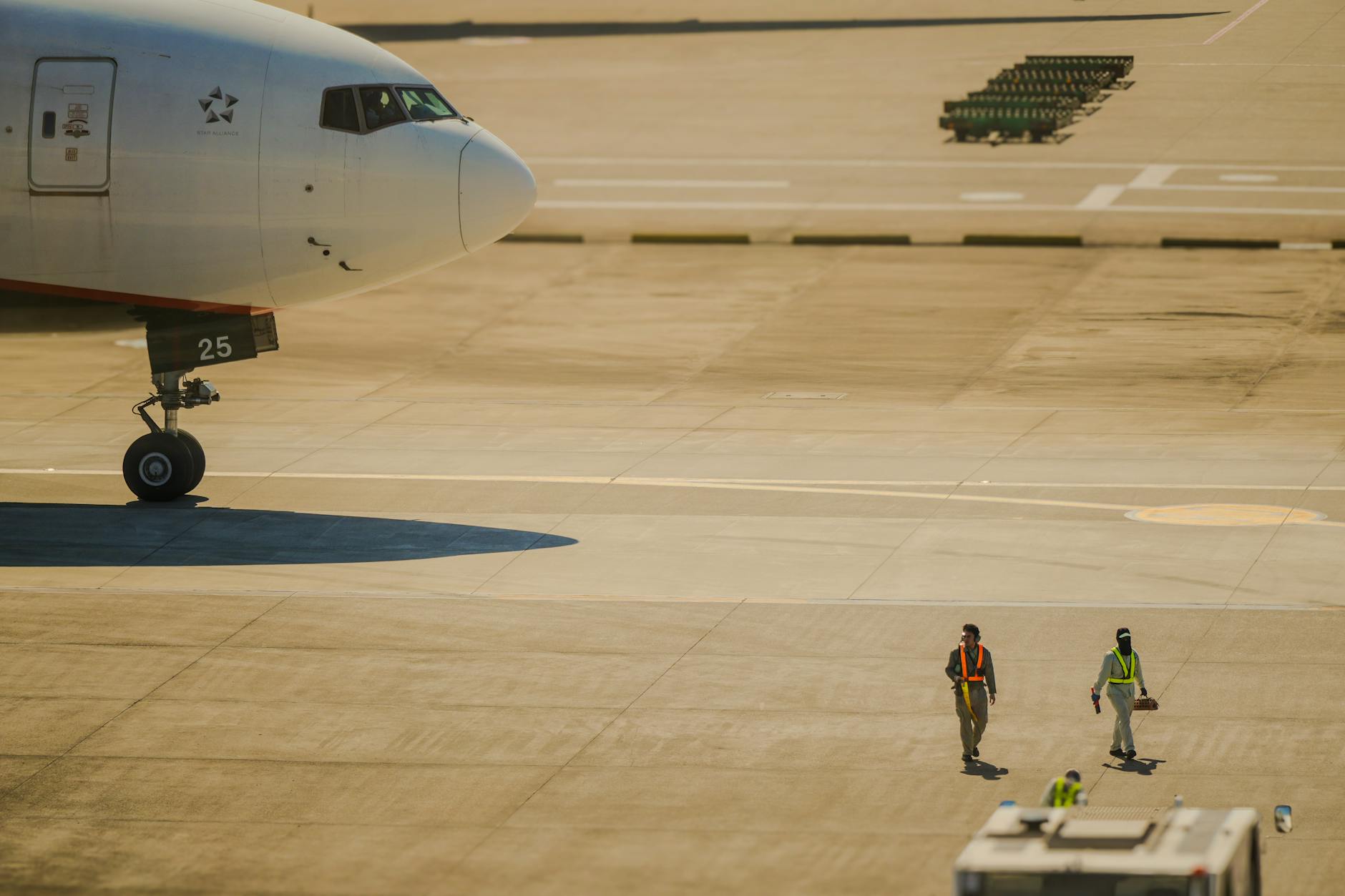 Airport gate agent helping passengers with boarding process and luggage