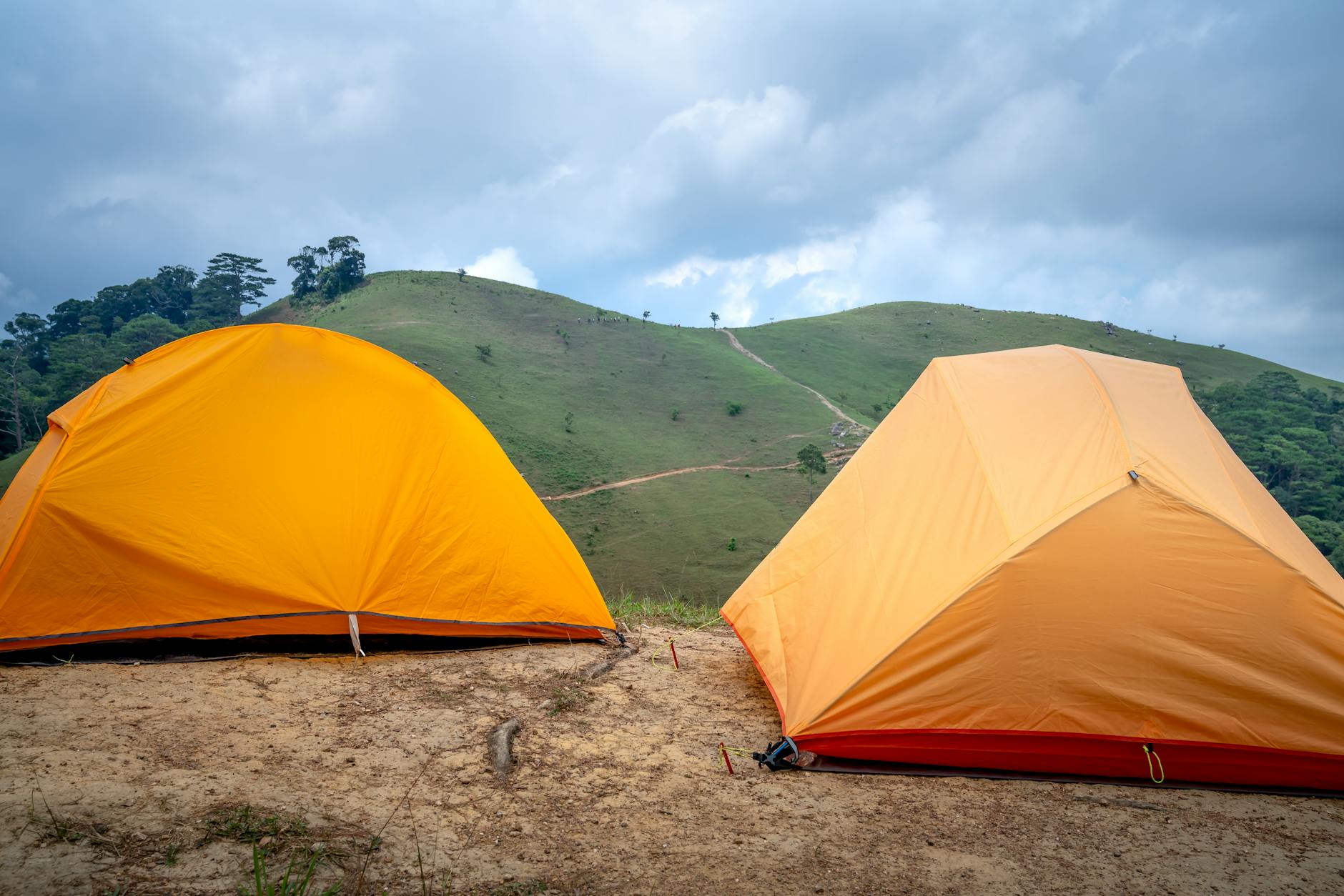 Trekking camp with tents set up on a high-altitude plateau at sunset