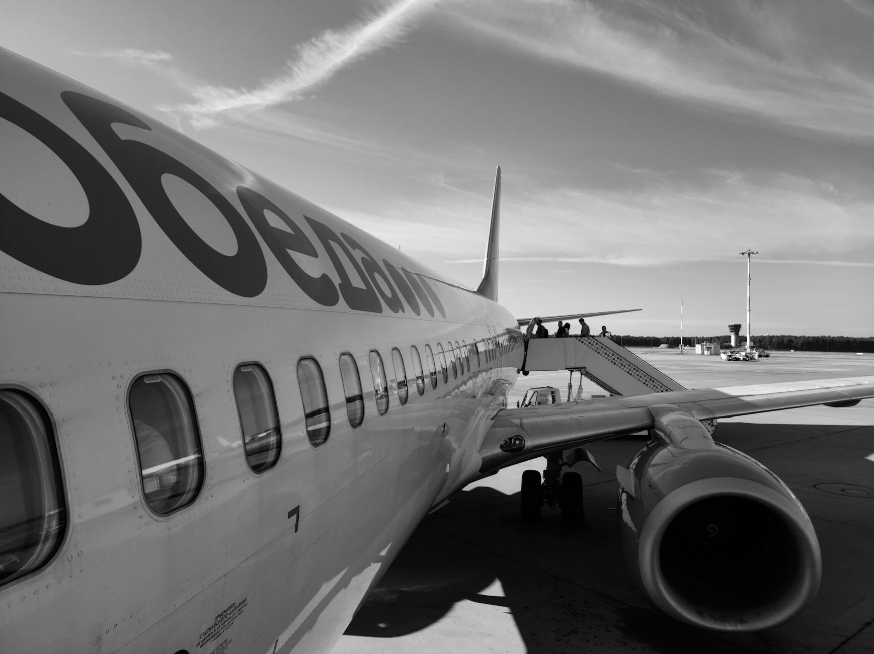 Passengers boarding commercial aircraft through jet bridge