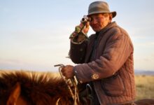 Wide open Mongolian steppe landscape with rolling grasslands under a vast blue sky