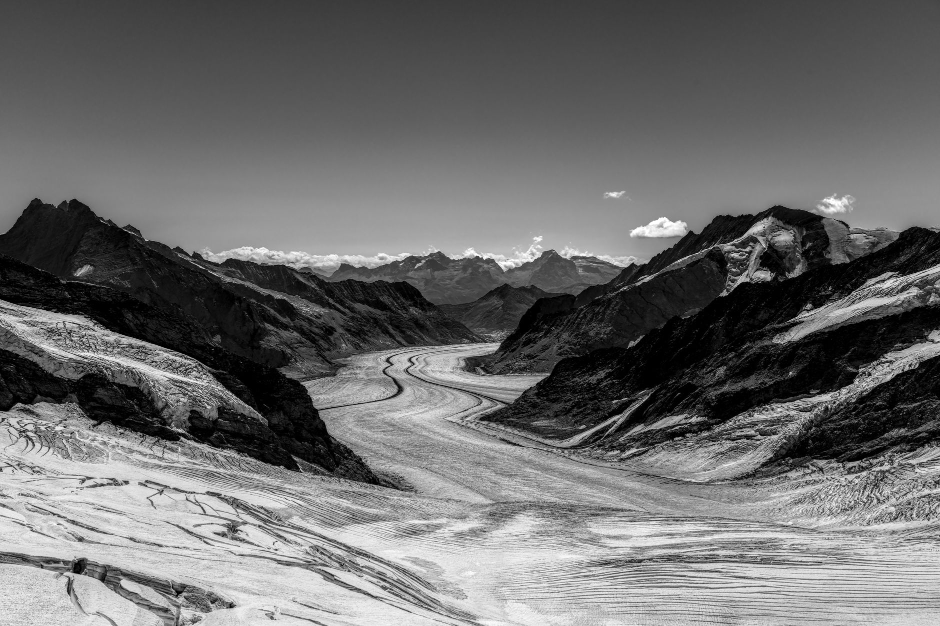 Wide glacial valley surrounded by snow-capped peaks in Central Asia