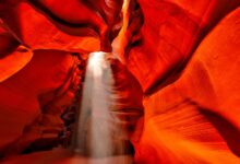 Rugged sandstone canyon formations rising from dry savanna landscape in Madagascar's Isalo National Park