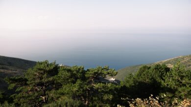 Turquoise waters along the Albanian Riviera with mountains rising behind the coast