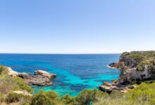 Calm turquoise waters and sandy shoreline of a Mediterranean island at golden hour