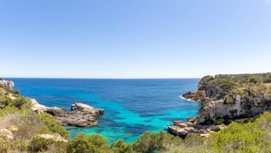 Calm turquoise waters and sandy shoreline of a Mediterranean island at golden hour