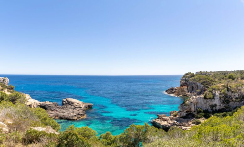 Calm turquoise waters and sandy shoreline of a Mediterranean island at golden hour
