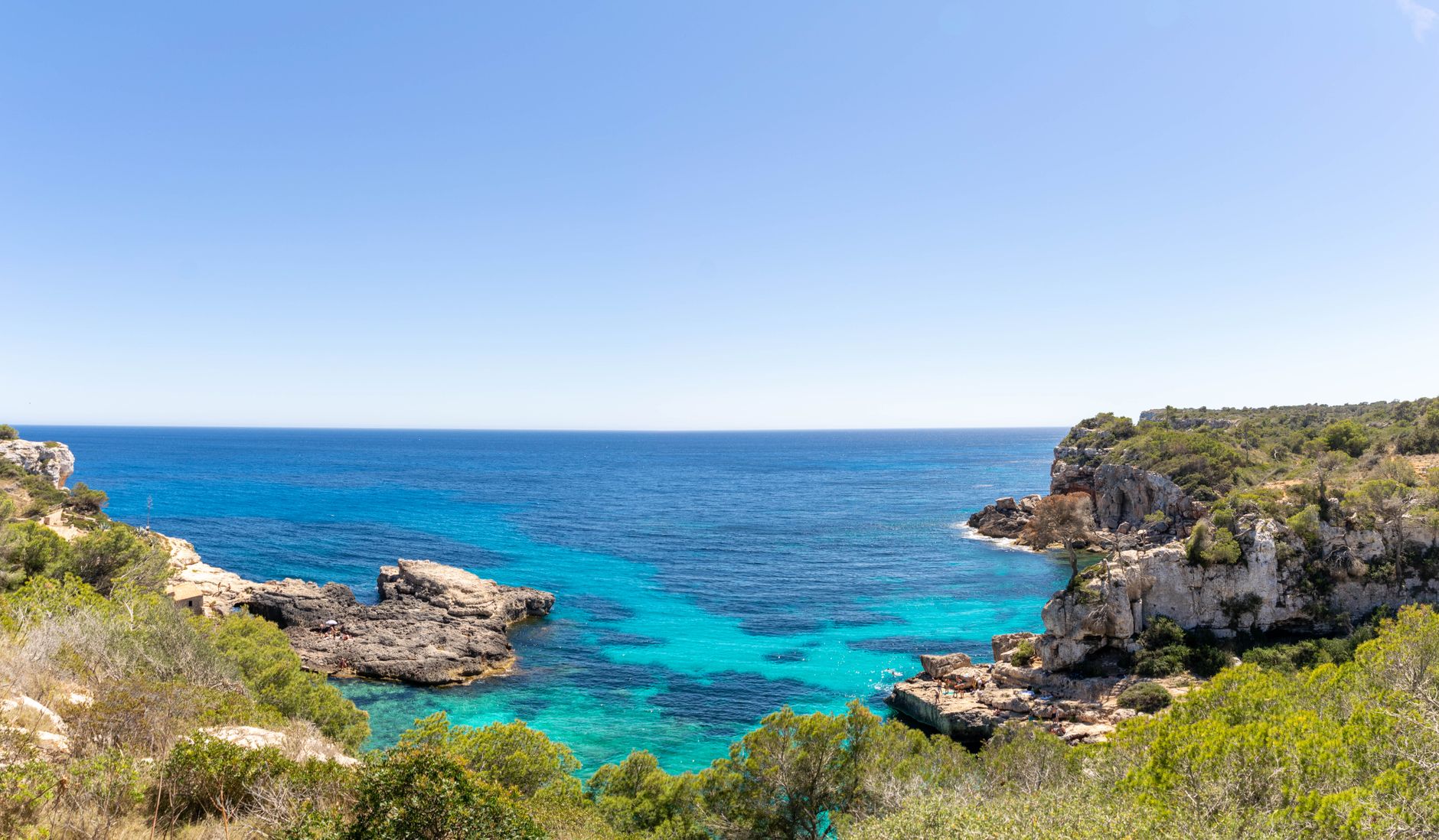 Calm turquoise waters and sandy shoreline of a Mediterranean island at golden hour