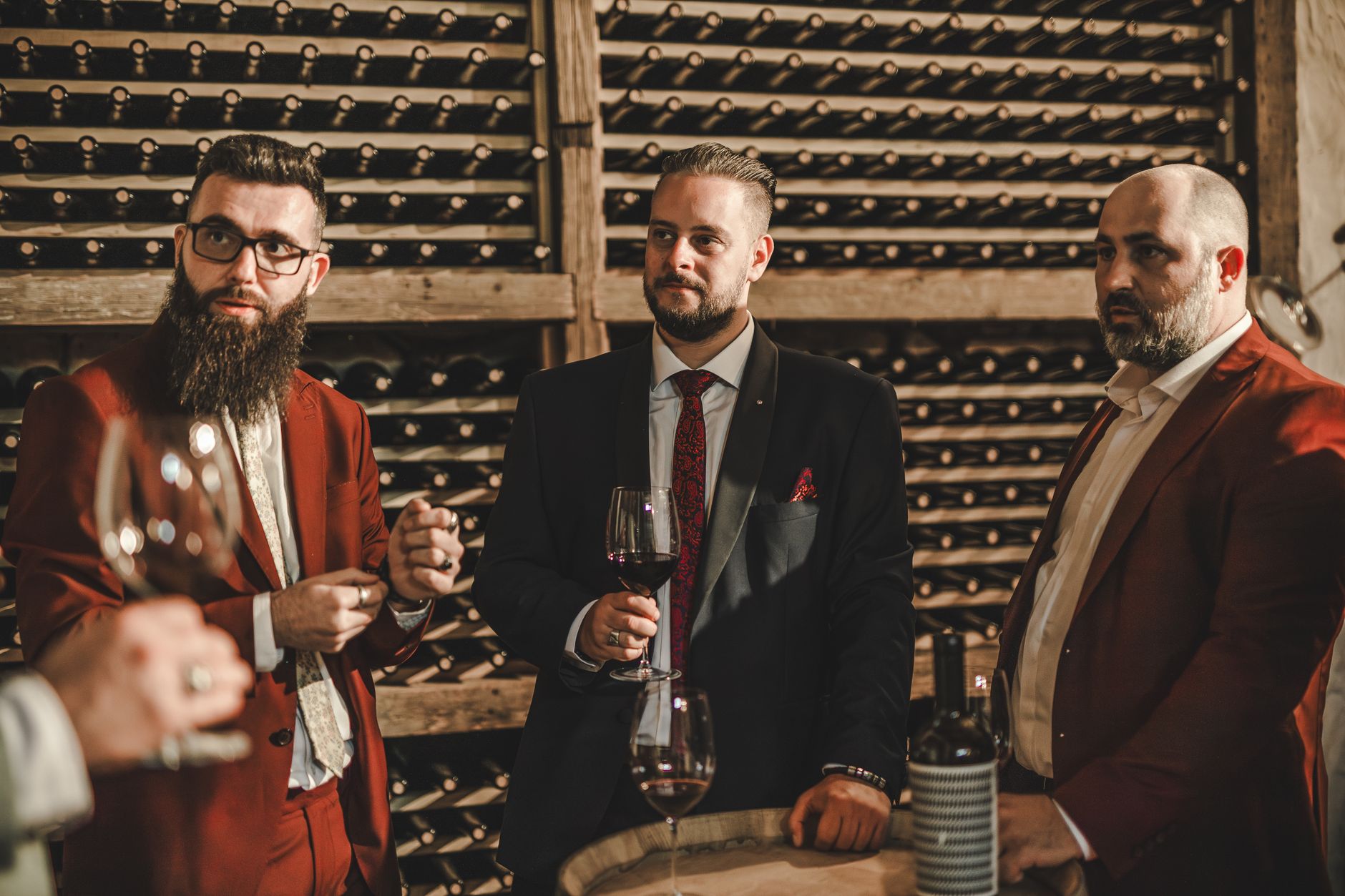 Wine barrels and tasting glasses inside an Argentine winery cellar