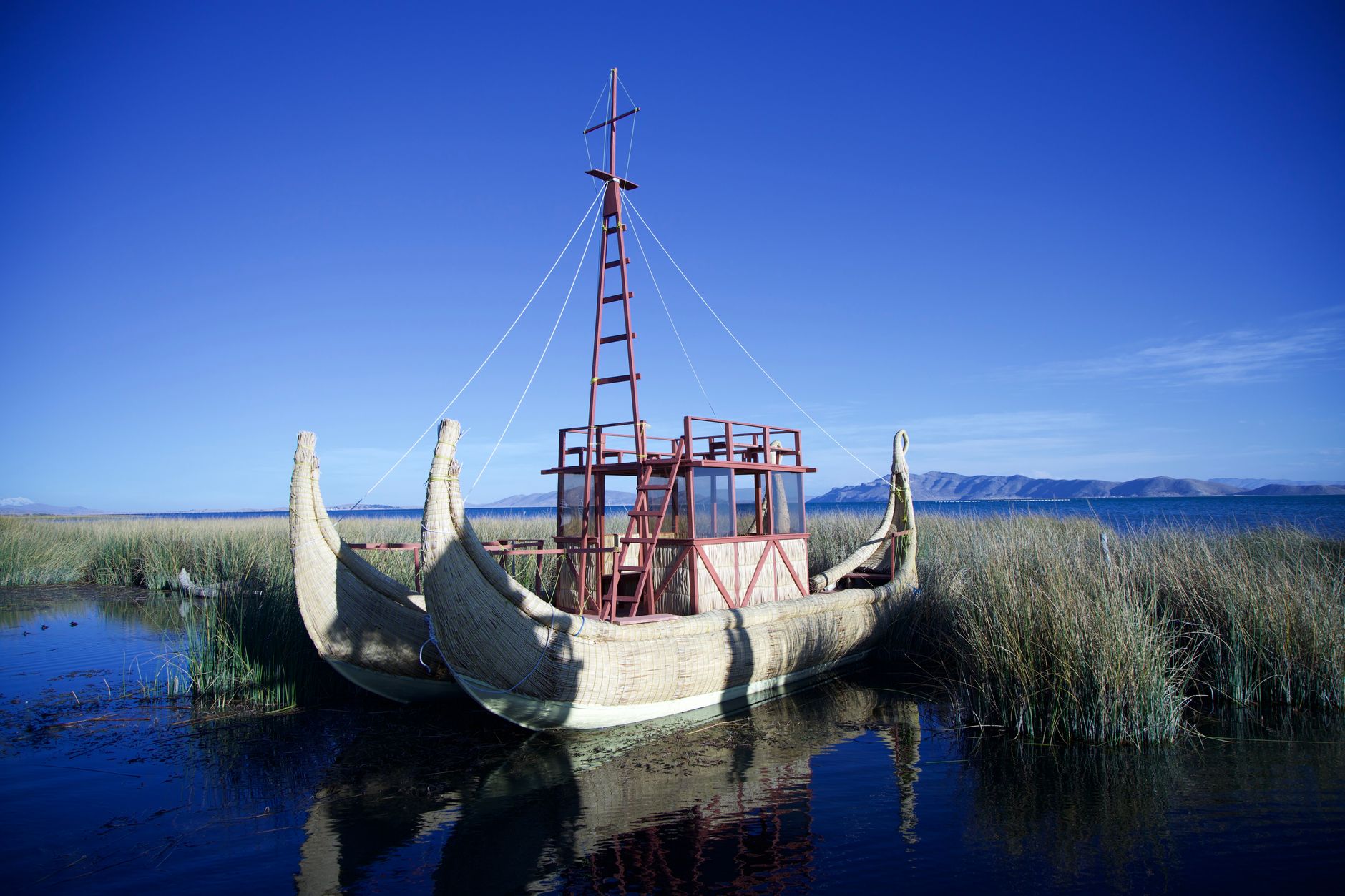Small wooden boats moored at a lakeside village in Bolivia