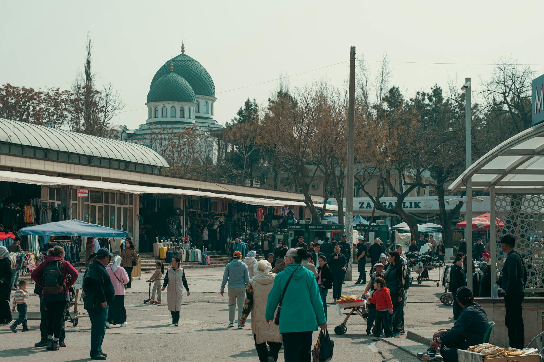 A busy outdoor market in Uzbekistan with spices, dried fruits, and local vendors