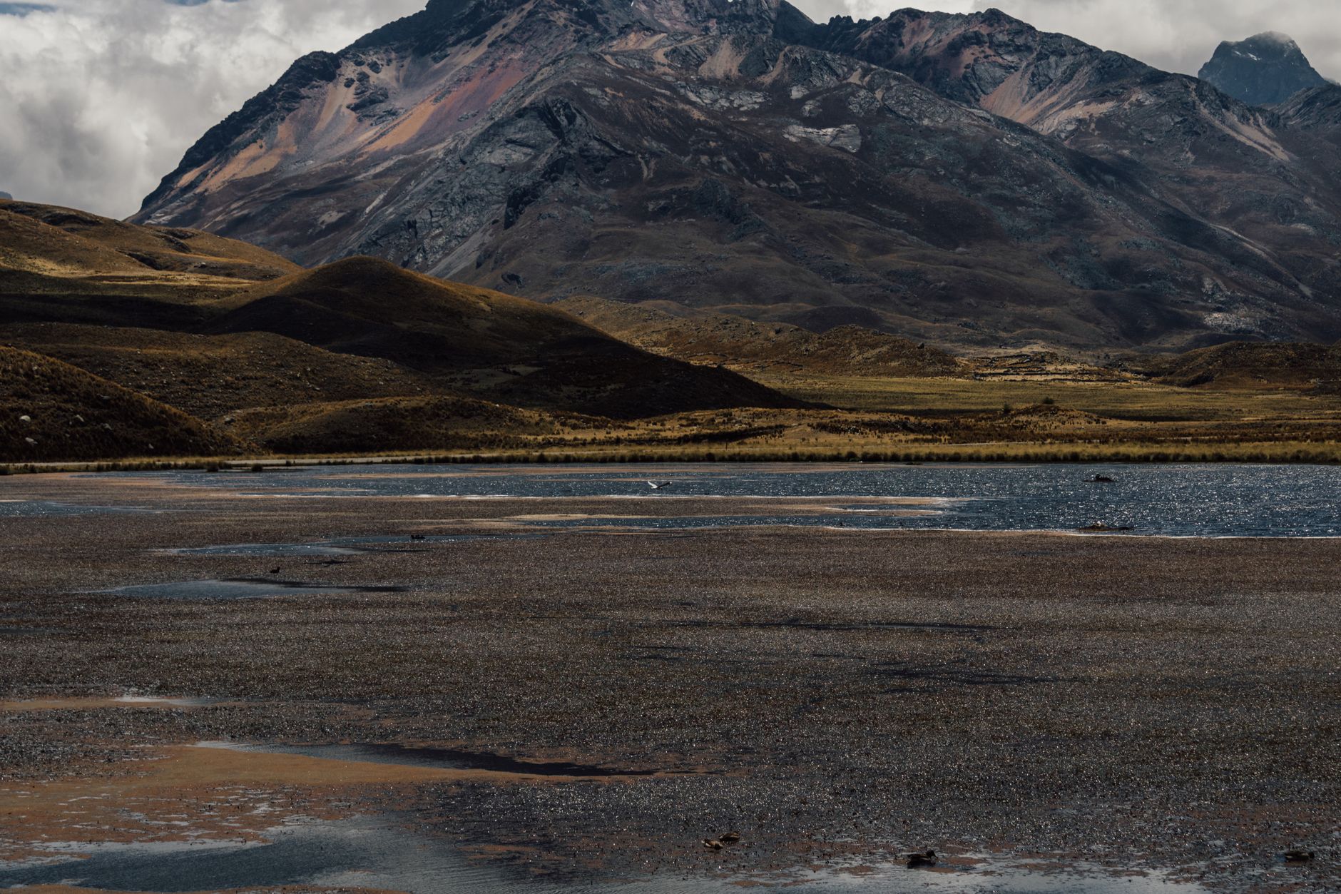 Terraced hillsides and traditional buildings on an Andean island overlooking calm lake waters