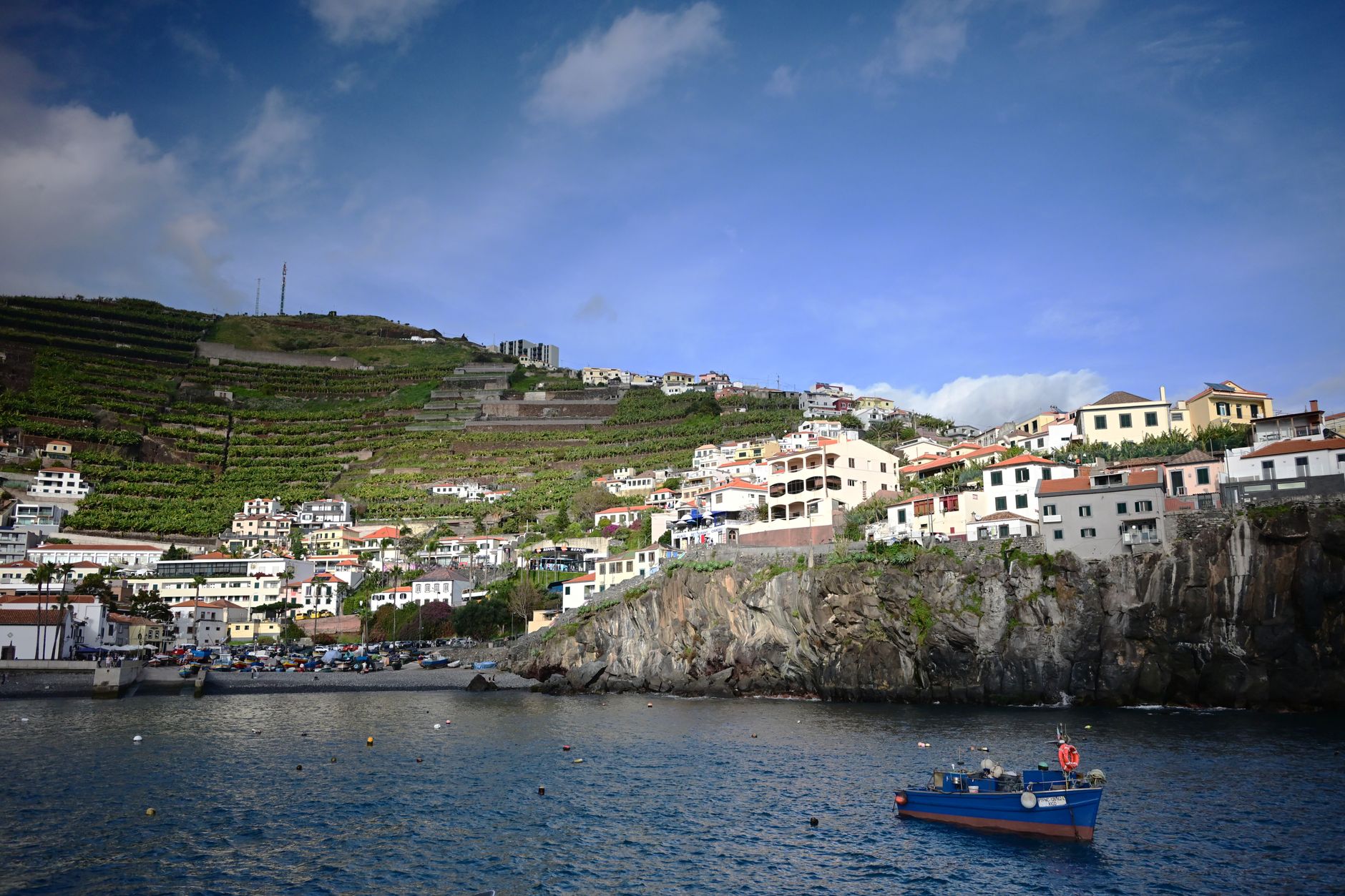 Traditional stone village surrounded by terraced vineyards on a Mediterranean hillside