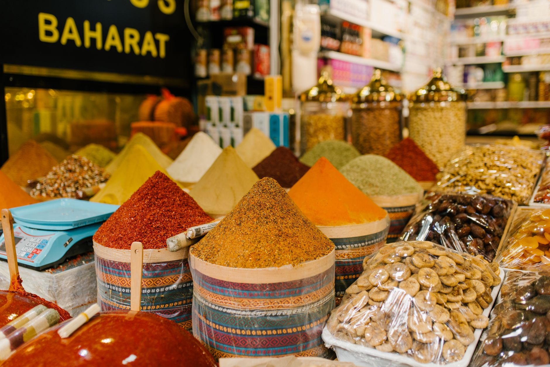 Colorful spice stalls and goods displayed in a traditional Middle Eastern covered bazaar