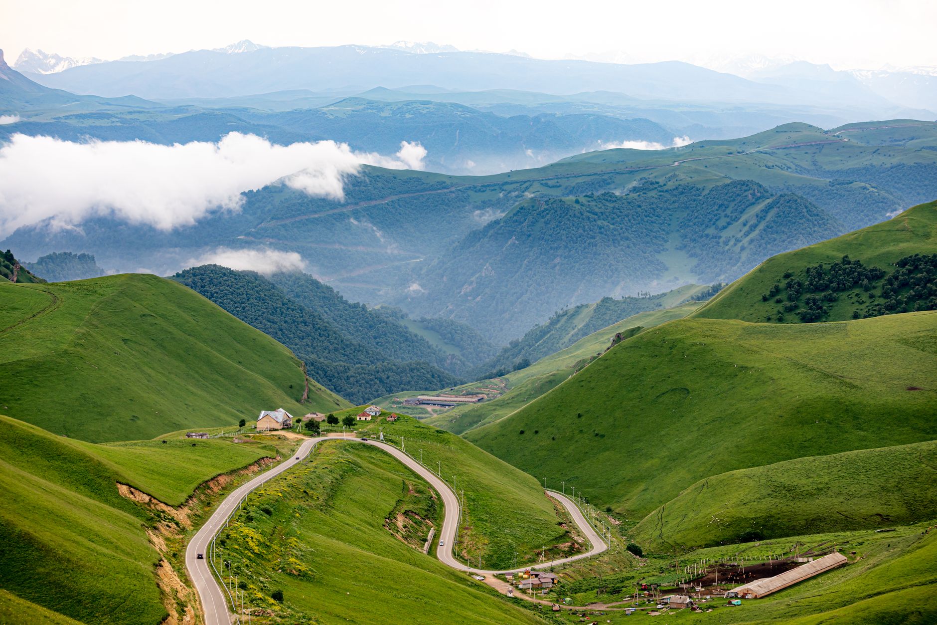 A winding road through a mountain valley in Central Asia during spring
