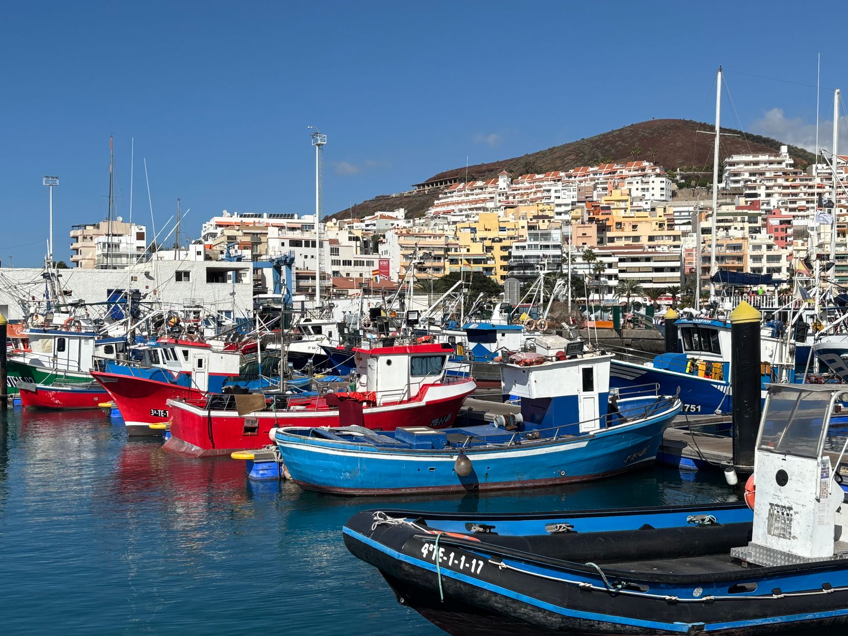 Small fishing boats moored at a quiet Mediterranean harbour at dusk
